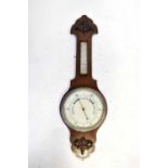 An early 20th century oak cased aneroid barometer.