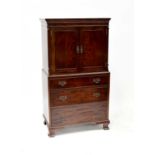 A reproduction flame mahogany veneered cocktail cabinet in the form of a small linen chest, two-door