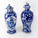 Two similar early 20th century blue and white lidded baluster vases, lids with dog of Fo finial