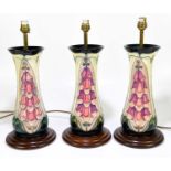RACHEL BISHOP FOR MOORCROFT; a set of three ceramic table lamps of waisted form in a foxglove