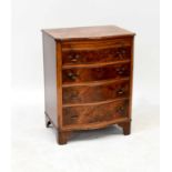 A reproduction mahogany bow front chest of four graduated drawers and shirt slide, raised on bracket