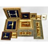 Ten highly polished brass taps mounted on velvet cushioned plinths in gilt frames, various shapes