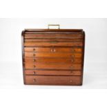 A mahogany desktop jewellery box with sunken brass campaign carry handle to the top, top drawer