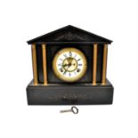 A Victorian black slate mausoleum mantel clock, the white enamelled dial set with Roman numerals,