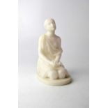 A marble statue of a young kneeling woman in Classical dress, on oval base, height 19.5 x 13cm.