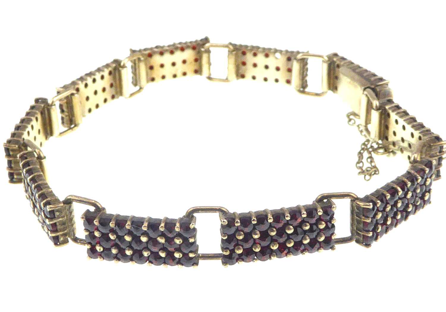 A Continental gilt silver (835 grade) garnet cluster bracelet comprising ten panels of twenty-one