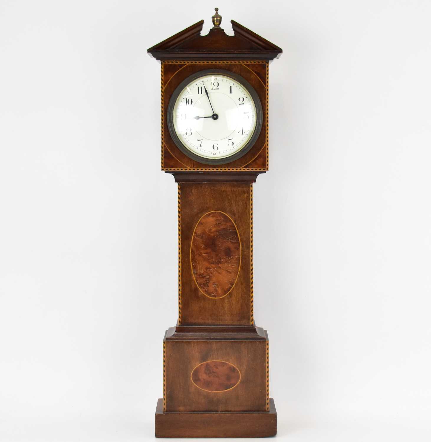 A late 19th/early 20th century miniature longcase clock with break arched top, the white enamelled
