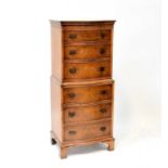 A walnut veneered chest on chest of small proportions, 130 x 55 x 42cm.Condition Report: One piece