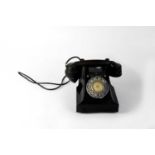 A black Bakelite telephone, GPO No. 312L SWE 61/3A GPO batch sampled 6971, with dial.