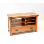 A modern oak joint side table with open drawers above a cupboard door, on stile feet, 69 x 110 x