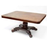 A large 19th century tilt-top table with rounded rectangular top above octagonal baluster column, to