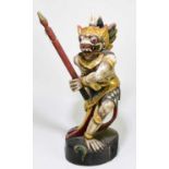 A painted Balinese figure of a mythical warrior, height 59cm.