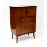 A vintage walnut veneered side cabinet with pair of panelled doors above three drawers, raised on