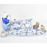 ROYAL COPENHAGEN; three porcelain ornaments to include a fieldmouse, height 7cm, otter with fish and