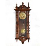A large walnut cased spring driven Vienna wall clock, with architectural arched pediment and