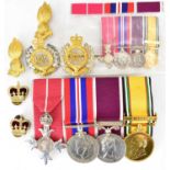 A group of four medals comprising an OBE and ribbon, a George VI War Medal, Elizabeth II 'Long