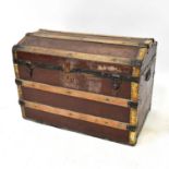 A 19th century wooden dome-topped faux leather chest, with wooden and brass laths, two carry