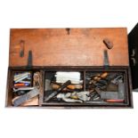 A large collection of tools comprising three wooden chests and an additional box, each containing