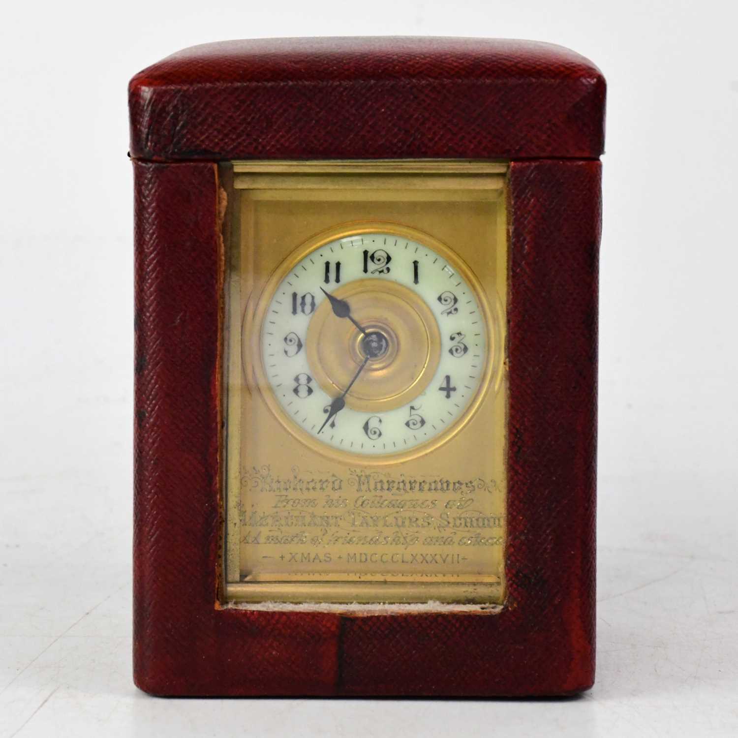 A late 19th century leather cased brass carriage clock, the chapter ring set with Arabic numerals,