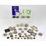 A group of coins including commemorative crowns, £2 coins, 50p coins and a £1 coin.