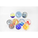 Ten modern glass paperweights to include Royal Crest 'Saturn' example, a Langham example, Murano,