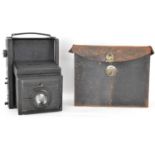 A vintage folding Mentor half plate camera and four plates, in leather carry case.