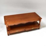 A pine two-tier coffee table with pair of frieze drawers, on turned supports, 45 x 114 x 54cm.