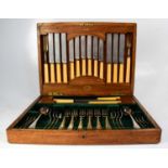 An early 20th century oak cased canteen of plated cutlery, bearing brass plaque inscribed 'Minerva