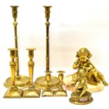 A large brass cherub playing panpipes and drum, with draped gown, on marble base, height approx.