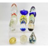 Eleven glass paperweights including novelty examples, seated dog, apple, cone-shaped spirals and