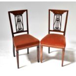 Four Edwardian mahogany inlaid dining chairs with acanthus and shell inlay to carved splat back,