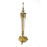 An Edwardian brass standard lamp of Neo-Classical design, with telescopic column, raised on goat