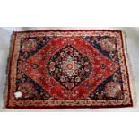 A Turkmenistan Meshed hand knotted red ground rug, 200 x 140cm (af).Condition Report: There is a