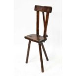 An unusual 19th century rustic ash and elm cutler's chair with exaggerated raised back and three
