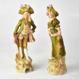 ROYAL DUX; a pair of figures, a gentleman and lady in 18th century dress, on Rococo-style bases,