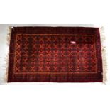 A Turkmenistan Beluch red ground hand-knotted rug, 224 x 1.33cm.