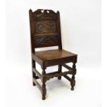 An early 18th century oak back stool with carved panel, plank seat and block turned legs.Condition