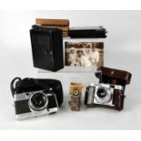 A Coronet 'Midget' camera (box af), a Voightlander camera, a Minolta camera, Box Brownie style