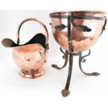 A 19th century copper and wrought iron planter, the dome-shaped copper planter nestling in a wrought