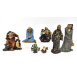 Six ceramic Oriental figures of varying forms and sizes, to include a seated fisherman with