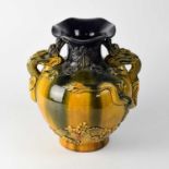 An early 20th century amber and purple drip glaze baluster vase with applied dragon, floral and