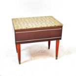 A 1950s vintage sewing box with quilted lift-up lid and fitted interior, on circular tapering