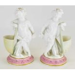 A pair of 19th century Staffordshire white porcelain figures depicting two cherubs with grapes and