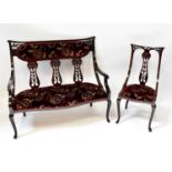 An early 20th century walnut four-piece salon suite comprising a three-seater open arm settee with