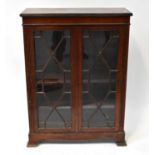 A reproduction mahogany display cabinet of small proportions, with pair of astragal glazed doors