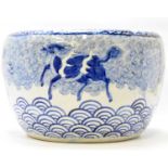 A mid-20th century large Chinese blue and white painted planter decorated with dragon dogs in