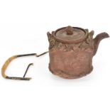 A late 19th/early 20th century Yixing teapot of square form, with textured body, impressed Chinese