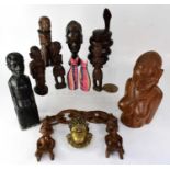 A small group of contemporary African carvings, including figures and busts.