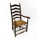 A 19th century country made rush-seated ladder back open arm elbow chair and an oak side chair (2).