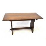 A mid-20th century oak refectory-style dining table with slab ends and cross stretcher, 74 x 137 x
